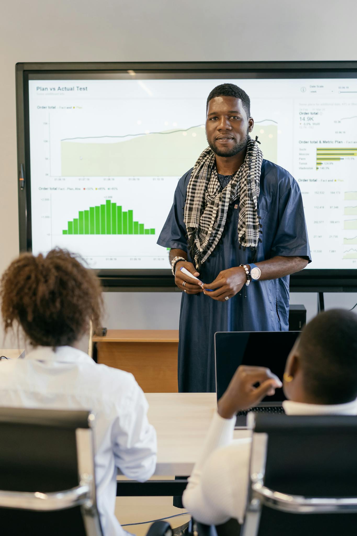 Business professional presenting data analysis in modern office setting.